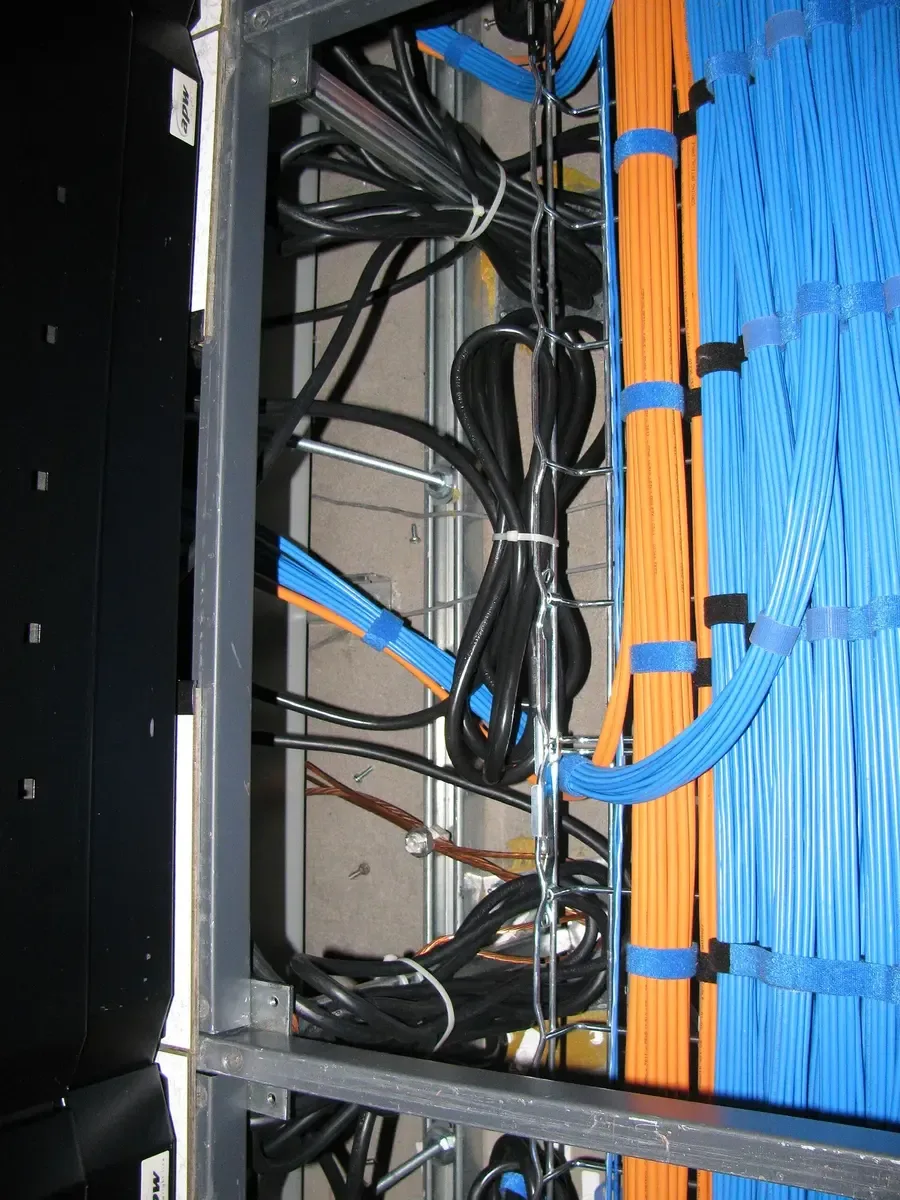 Structured fiber and copper cable runs in a network rack